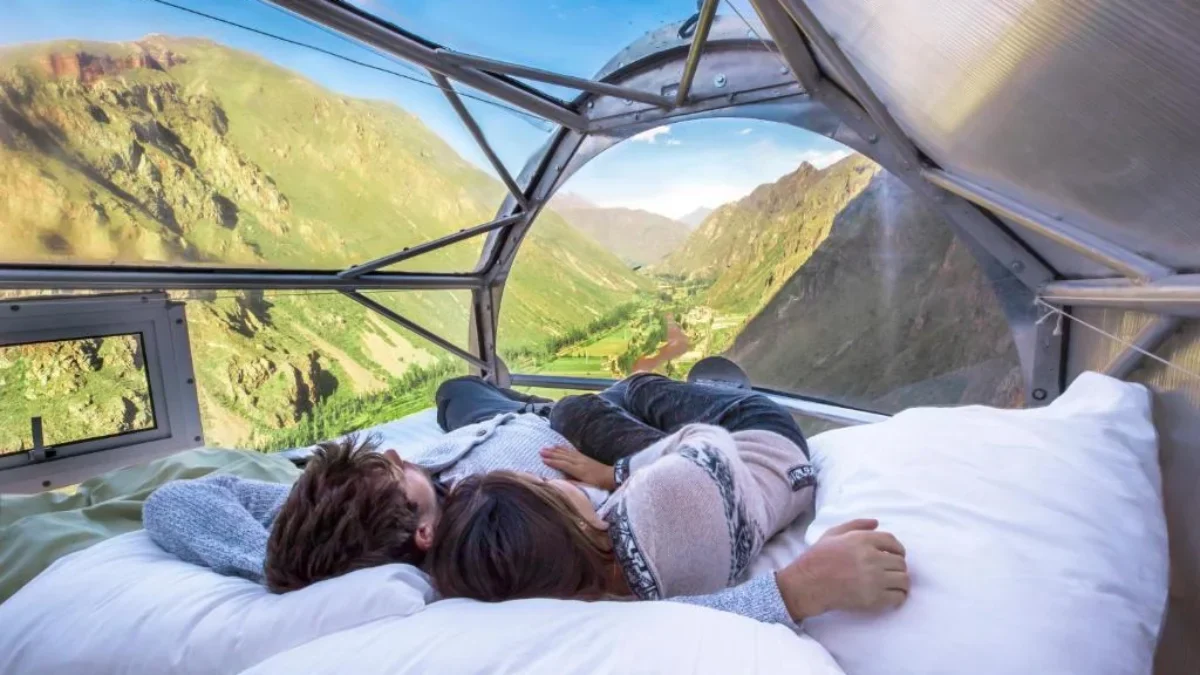 Editorial blog image: a couple relaxing in a panoramic capsule overlooking the mountains